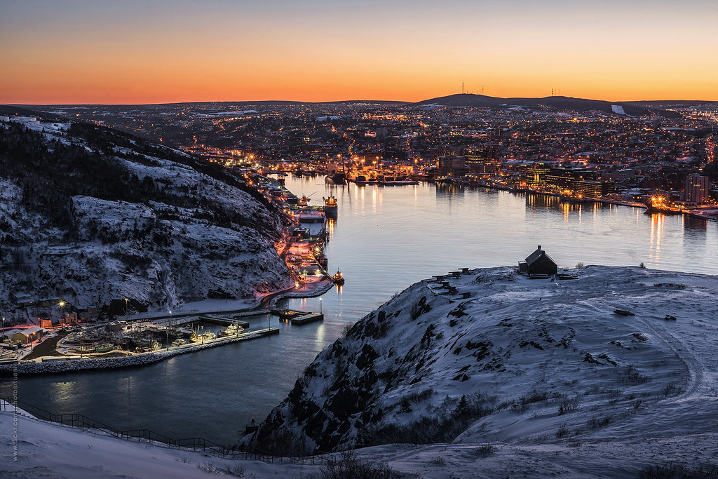 Sunset view from Signal Hill overlooking St. John’s Harbour, Newfoundland, showing the downtown waterfront and surrounding hillsides during winter